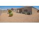 Landscaped backyard featuring desert landscaping with gravel, shrubs, and a covered patio for outdoor enjoyment at 2420 E San Borja Trl, Casa Grande, AZ 85194