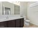 Bathroom featuring a single sink vanity with a dark wood finish and a large mirror at 2420 E San Borja Trl, Casa Grande, AZ 85194