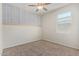 Neutral bedroom with carpet, ceiling fan, a bright window, and an accent wall at 2420 E San Borja Trl, Casa Grande, AZ 85194