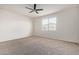 Spacious bedroom featuring a ceiling fan, carpeted floor and a window at 2420 E San Borja Trl, Casa Grande, AZ 85194