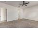 Bedroom with ceiling fan, carpet flooring, neutral paint, and a doorway to the bathroom at 2420 E San Borja Trl, Casa Grande, AZ 85194