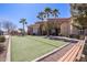 Outdoor bocce ball court with manicured landscaping, benches, and nearby community building at 2420 E San Borja Trl, Casa Grande, AZ 85194