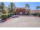 Clubhouse with a grand archway entrance, palm trees, and accessible parking at 2420 E San Borja Trl, Casa Grande, AZ 85194