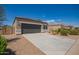 Charming single-story home with a well-manicured front yard, two car garage, and neutral colored stucco at 2420 E San Borja Trl, Casa Grande, AZ 85194