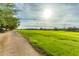 View of lush green golf course with mature trees and a walking path on a sunny day at 2420 E San Borja Trl, Casa Grande, AZ 85194