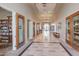 Elegant hallway with tiled floors, library and doors leading to various clubhouse amenities at 2420 E San Borja Trl, Casa Grande, AZ 85194