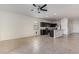 Inviting open-concept living area with modern ceiling fan, neutral walls, and a view into the kitchen and dining area at 2420 E San Borja Trl, Casa Grande, AZ 85194