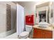 Bathroom featuring shower-tub combo, stylish vanity and decorative tile accents at 27406 N 22Nd Ln, Phoenix, AZ 85085