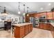 Open kitchen featuring granite countertops, stainless steel appliances, island with bar seating, and tile flooring at 27406 N 22Nd Ln, Phoenix, AZ 85085