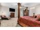 A large main bedroom boasts a chaise lounge, TV, carpet, and a regal-looking bed at 27406 N 22Nd Ln, Phoenix, AZ 85085