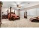 A large main bedroom features a regal-looking bed, neutral carpet, and a ceiling fan with lights at 27406 N 22Nd Ln, Phoenix, AZ 85085