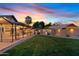 Large, grassy backyard featuring a covered patio, lush greenery, and ambient lighting, perfect for outdoor gatherings and relaxation at 2747 S Brooks --, Mesa, AZ 85202