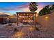 Inviting backyard patio featuring a pergola, stylish seating, and a cozy fire pit area enhanced by ambient lighting at 2747 S Brooks --, Mesa, AZ 85202