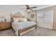 Comfortable bedroom featuring a wooden bed frame, ceiling fan, and a bright window with shutters at 2747 S Brooks --, Mesa, AZ 85202