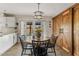 Bright dining area with a round table, adjacent to white cabinets and wooden sliding doors to the backyard at 2747 S Brooks --, Mesa, AZ 85202