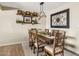 Elegant dining room with wooden table, decorative wall art, and stylish shelving with picture frames at 2747 S Brooks --, Mesa, AZ 85202