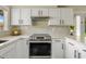 Well-equipped kitchen with stainless steel range, white cabinets, and decorative backsplash tiling at 2747 S Brooks --, Mesa, AZ 85202