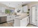 Bright kitchen featuring white cabinets, stainless steel appliances, quartz countertops, and an eat-in island at 2747 S Brooks --, Mesa, AZ 85202