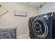 Modern laundry room with blue washer/dryer set and decorative tile accent wall at 2747 S Brooks --, Mesa, AZ 85202