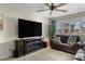 Comfortable living room featuring a large TV, plush seating, and natural light from the window at 2747 S Brooks --, Mesa, AZ 85202