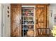 Organized pantry with sliding wooden doors, providing ample storage space for kitchen essentials at 2747 S Brooks --, Mesa, AZ 85202