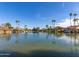 Beautiful lake view showcasing waterfront homes and palm trees against a clear blue sky at 2747 S Brooks --, Mesa, AZ 85202