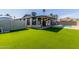 This backyard has an outdoor patio and pool area with an artificial grass lawn at 28 W Hillside St, Mesa, AZ 85201