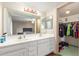 Bathroom with dual sinks, large mirror, and walk-in closet at 28 W Hillside St, Mesa, AZ 85201