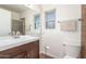 Bathroom featuring a modern vanity with a dark wood finish, and tiled shower at 28 W Hillside St, Mesa, AZ 85201