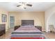 Bedroom featuring neutral tones, ceiling fan, and wood-look floors at 28 W Hillside St, Mesa, AZ 85201