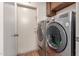 This laundry room has a modern washer and dryer set and a door leading to the outside at 28 W Hillside St, Mesa, AZ 85201