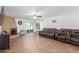 Spacious living room featuring tile floors, ceiling fan, and a cozy fireplace with sliding door access to back at 28 W Hillside St, Mesa, AZ 85201