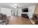 Spacious living room featuring tile floors, ceiling fan, and a cozy fireplace with sliding door access to back at 28 W Hillside St, Mesa, AZ 85201