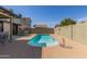 This backyard features a pool with patio furniture and has block wall for privacy at 28 W Hillside St, Mesa, AZ 85201