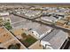 Aerial view of a neighborhood with well-maintained lawns and houses with desert landscaping at 30747 W Indianola Ave, Buckeye, AZ 85396