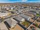 A birds eye view of houses with gravel yards and lush green lawns in a desert community at 30747 W Indianola Ave, Buckeye, AZ 85396