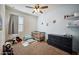 bedroom with a crib, dresser, and ceiling fan at 30747 W Indianola Ave, Buckeye, AZ 85396