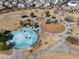 Aerial view of a park with a playground, splash pad, and walking paths at 30747 W Indianola Ave, Buckeye, AZ 85396