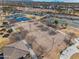 Community center with aerial view of tennis courts, volleyball and basketball courts, and lush landscaping at 30747 W Indianola Ave, Buckeye, AZ 85396