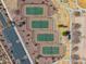 Aerial view of fenced tennis courts and parking lot surrounded by trees in a park at 30747 W Indianola Ave, Buckeye, AZ 85396