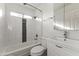 Clean bathroom featuring white tiles, updated fixtures, and a shower-tub combination at 324 W Culver St # 2, Phoenix, AZ 85003