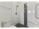 Modern bathroom featuring white tile walls, a shower, and black mosaic tile accents at 324 W Culver St # 2, Phoenix, AZ 85003