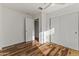 Bright bedroom featuring hardwood floors, a ceiling fan, a closet, and white walls at 324 W Culver St # 2, Phoenix, AZ 85003