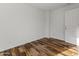 Empty bedroom with hardwood floors, neutral paint, and a closed door at 324 W Culver St # 2, Phoenix, AZ 85003