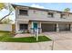 Charming townhouse with a teal front door, awning, and attached two-car garage at 324 W Culver St # 2, Phoenix, AZ 85003