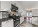 Modern kitchen featuring stainless steel appliances, mosaic backsplash, and white cabinetry at 324 W Culver St # 2, Phoenix, AZ 85003