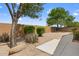 Landscaped backyard featuring desert vegetation, a stone accent, gravel, and a block wall for added privacy at 337 S 172Nd Dr, Goodyear, AZ 85338