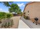 The backyard features desert landscaping with a gravel covering, a concrete walkway, and a grill at 337 S 172Nd Dr, Goodyear, AZ 85338