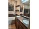 Bathroom featuring double sink vanity, stand alone tub, and glass-doored shower at 337 S 172Nd Dr, Goodyear, AZ 85338