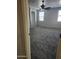 Spacious carpeted bedroom featuring neutral walls, ceiling fan, and natural light streaming through the windows at 337 S 172Nd Dr, Goodyear, AZ 85338